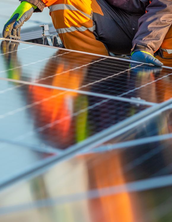 worker placing a solar panel