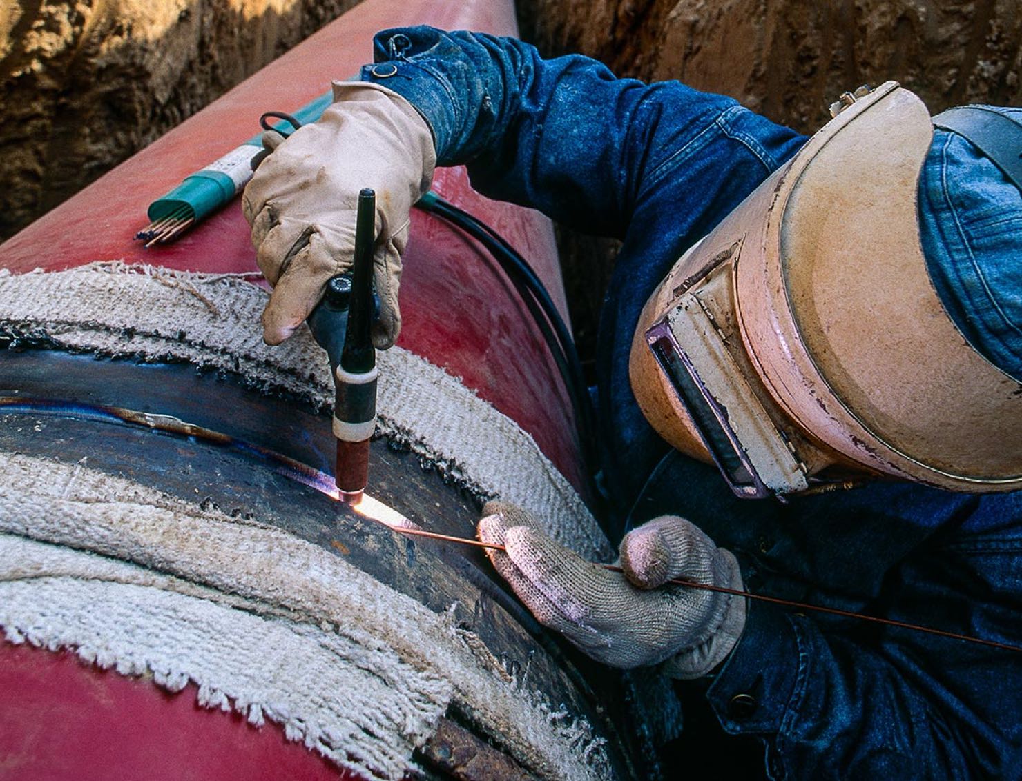 worker welding pipe