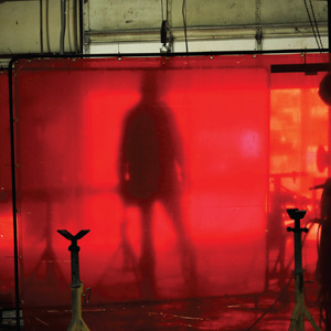 man behind large red panel